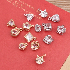 DIY jewelry charms with clear zircon in star and heart shapes on a red background