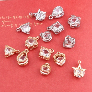 Macro shot of assorted geometric metal pendants with cubic zirconia for DIY jewelry making