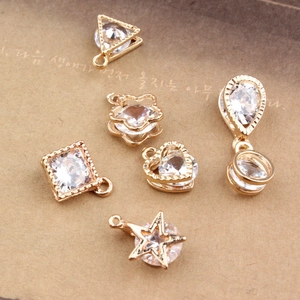 Macro shot of assorted gold-plated zircon charms for DIY jewelry making accessories