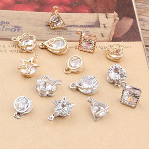 Macro shot of assorted geometric zircon charms in gold and silver for DIY jewelry