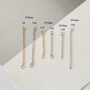 Detail view of gold and silver plated copper tassel chain charms in various sizes