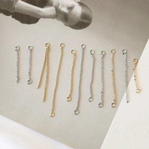 Macro shot of assorted gold and silver tassel extension chains for DIY jewelry making