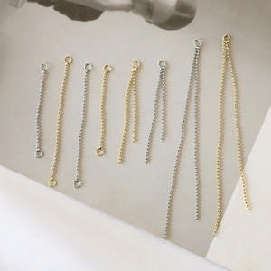 Detailed view of gold and silver bean tassel chain connectors for DIY jewelry making