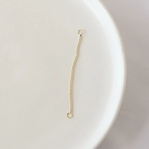 Close-up of gold-plated bead chain with loops for DIY jewelry making and earrings