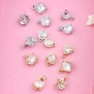 Macro shot of 12pcs DIY jewelry pendants with inlaid zircons in various geometric shapes