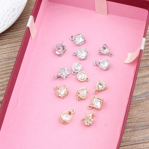 Detailed view of DIY jewelry pendants with inset zircons in various geometric shapes