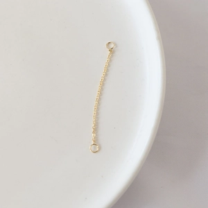 Close-up of gold-plated tassel chain connector with rings for DIY jewelry making