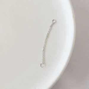 Detailed close-up of a silver-plated connector chain with two closed loops for DIY jewelry