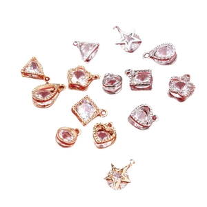 Assorted gold and silver DIY charms with embedded zircon stones in geometric shapes