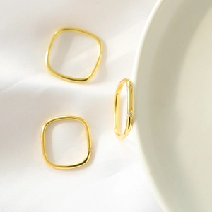 Three-piece gold plated square ring set with minimalist zircon stones on smooth metal