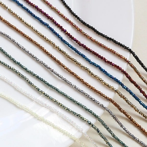 Multi-color faceted crystal glass rondelle beads for DIY jewelry making on white plate