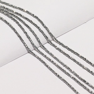 Detailed macro view of 2-3mm faceted grey metallic beads for DIY jewelry making