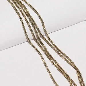 Detailed macro view of faceted gold metallic beads for DIY jewelry making and craft projects