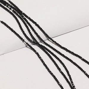 Close-up of 2mm black faceted glass crystal beads for DIY jewelry and necklace making