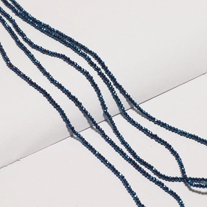 Macro shot of faceted deep blue crystal rondelle beads for DIY jewelry making