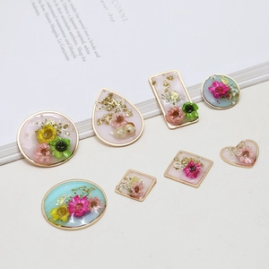 Handmade resin dried flower pendants in geometric gold frames for DIY jewelry