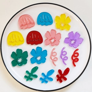 Macro shot of colorful translucent acrylic flower and jellyfish charms for DIY jewelry