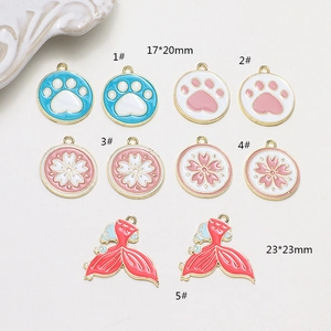 Detail of DIY alloy charms featuring paw prints, flowers, and fish tail pendants