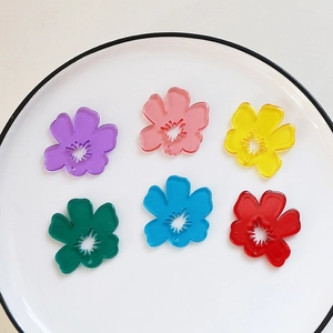 Flat lay of colorful acrylic tulip flower pendants for DIY jewelry making