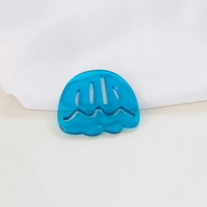 Macro detail of a blue translucent tulip-shaped acrylic pendant with precise cut-out design
