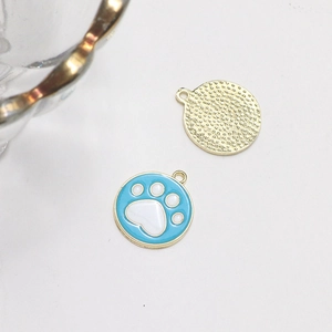 Blue enamel charms with white paw prints and textured gold metal back for jewelry DIY