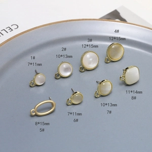 Detail of 925 silver cat eye stone earring studs in various sizes on a grey tray