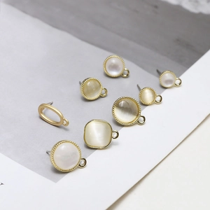 Detail of 925 silver cat eye stone earring studs with gold plated beaded edge textures