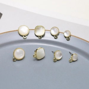 Macro view of gold-plated earring bases with opalescent cat eye stones for DIY jewelry