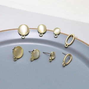 DIY jewelry kit with gold-rimmed cat eye stone studs and oval alloy charms for earrings