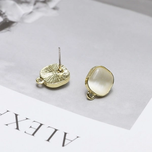 Detail of square gold ear stud bases with white cat-eye stone and DIY hanging loops