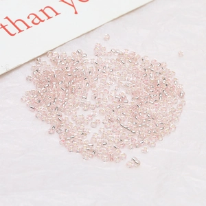 Macro shot of 2mm silver-lined pink seed beads for DIY jewelry and crafts