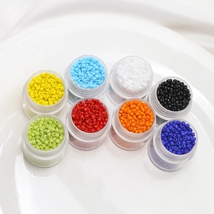 Detailed top view of 2mm colorful porcelain seed beads in 8 clear storage jars for DIY crafts