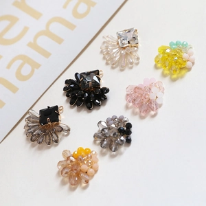 Macro shot of colorful handmade crystal bead pendants with gold wire wrapping