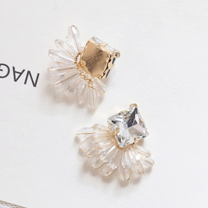 Detailed macro view of crystal earring with gold plating and champagne bead charms