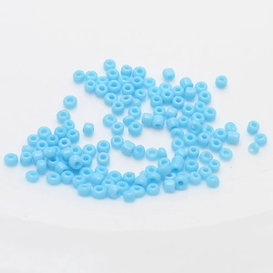 Detailed view of light blue 2mm ceramic seed beads for DIY handmade jewelry crafting