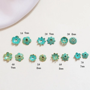 Detail of turquoise floral bead caps with gold edging in 7mm to 9mm sizes for jewelry