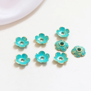 Macro view of blue flower alloy spacer beads with gold trim for DIY jewelry making