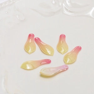 Macro view of gradient pink petal charms with realistic leaf veins for DIY jewelry