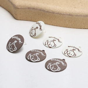 Detailed view of cute bear alloy earrings with brown and cream enamel drip finish
