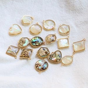 Vue détaillée des pendentifs géométriques en nacre d'abalone dorés pour bijoux DIY