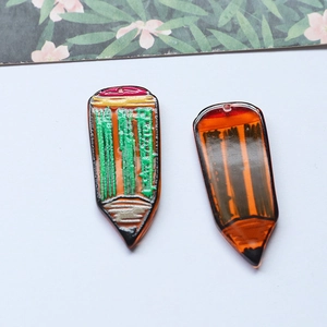 Detailed view of pencil-shaped resin charms with colorful patterns for DIY keychains