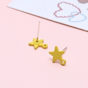Detail of yellow star stud earrings with S925 silver pins and a matte finish