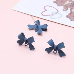 Detail of dark blue matte bow jewelry charms with loops for DIY earring making