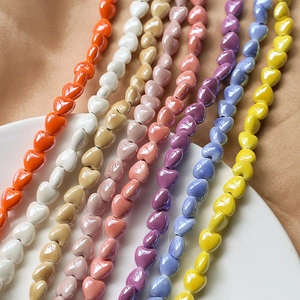 Close-up of colorful heart-shaped ceramic beads for DIY jewelry making in various shades