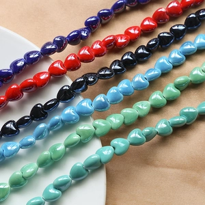 Macro view of colorful ceramic heart beads with high-gloss finish for DIY jewelry making