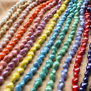Macro view of multi-colored glossy ceramic heart beads for DIY jewelry making