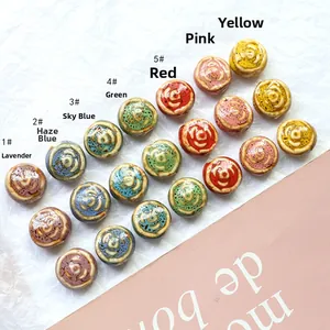 Macro detail of handmade rose-shaped ceramic beads with spiral texture in seven vintage colors
