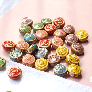Macro detail of handmade ceramic floral beads in vintage glazed colors for DIY jewelry