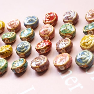 Close-up of vintage handmade ceramic beads with hand-painted spirals for DIY jewelry