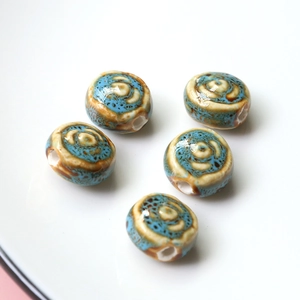 Detailed view of handmade vintage glazed ceramic flat round beads for jewelry making